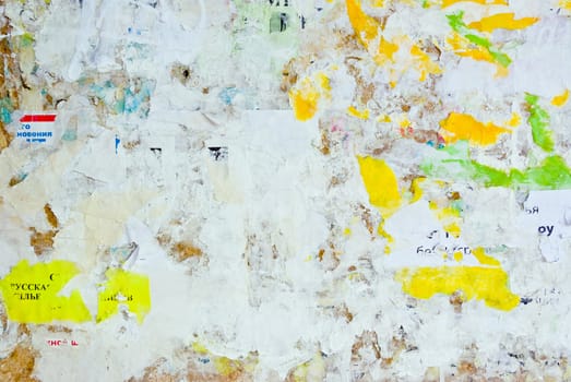 remains of posters and advertisements on old wall