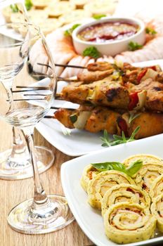 Many dishes of bite size appetizers and party food
