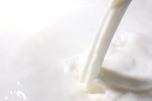 milk splashing into fresh milk with drops