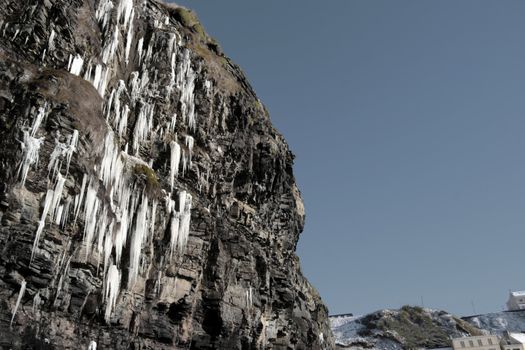 icicles on a cliff face melting in ballybunion ireland on a winters day