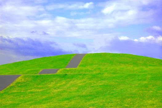 colorful grassland in summer under cloudy sky with path up the hill