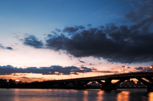 Modern bridge in the night under dramatic sky in Taipei, Taiwan.