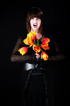 Pretty young vampire with bright plastic flowers