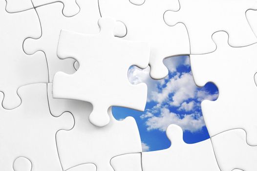 puzzle and blue cloudy sky showing freedom concept