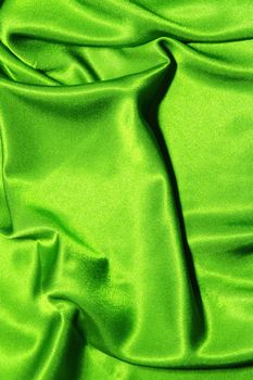 green satin or silk background with textile texture