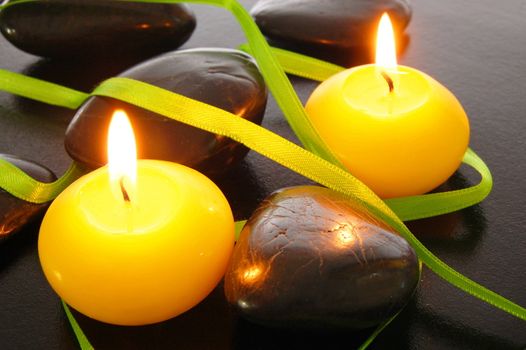 zen harmony with candles and stones on black background