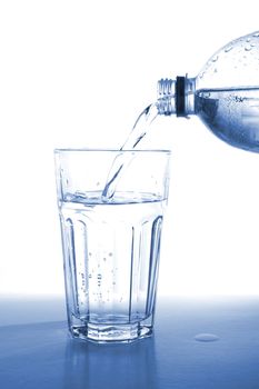 bottle of water isolated on white filling glass