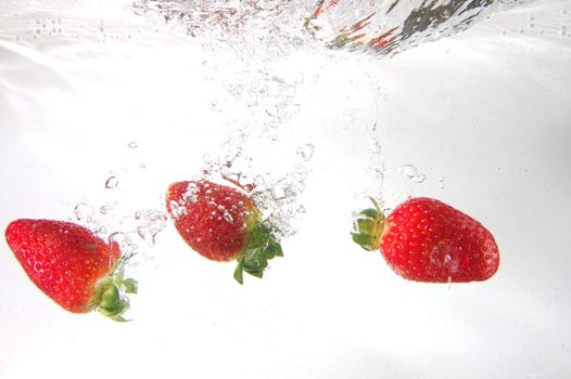 strawberry splash in water showing a fitness concept