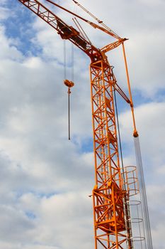 The yellow crane on the background of blue sky