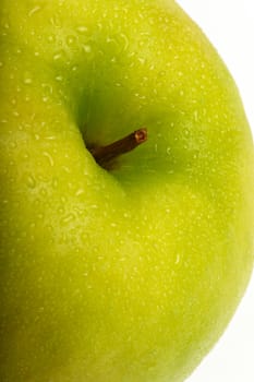 Green apple with water drops. Close-up