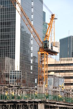 building construction site with crane and workers
