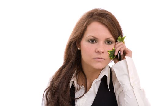 Pretty brunette making a call with a phone surrounded by Ivy