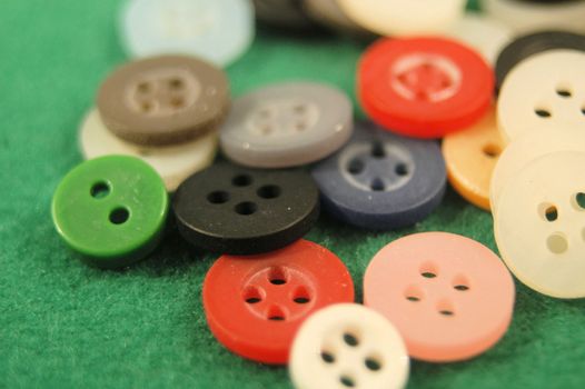 A pile of buttons on a field green