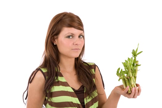 Pretty brunette holding young bamboo plants in her hands