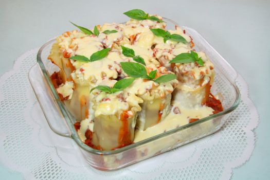 baked lasagna in tomato and white creamy sauce
