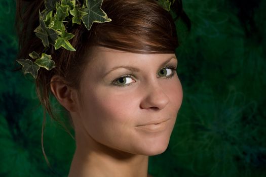 Pretty brunette with ivy in her hair and a pretty smile