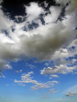 Clouds looming over the horizon with deep blue sky in background