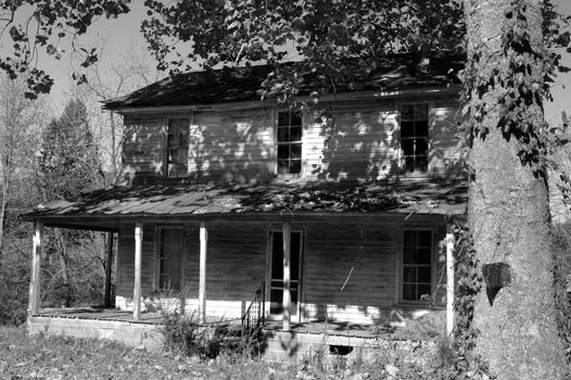 Black and white photo of an old abandoned house