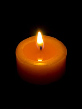 Closeup of a candle with black background.