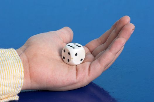 Dices in hand over blue background