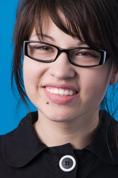 Girl in glasses, isolated on blue background.