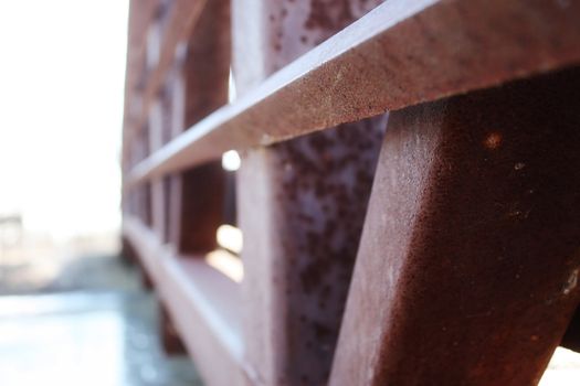 close up of a rusty bridge over a canal