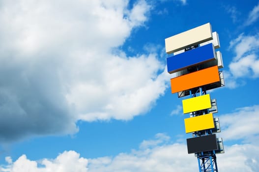 ulti-coloured billboard on a background of the blue sky with clouds