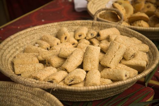 Sweet sesame pastries in a wicker basket. Shallow focus.