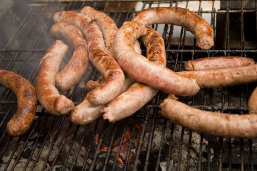 Highly seasoned pork sausage on a grill.