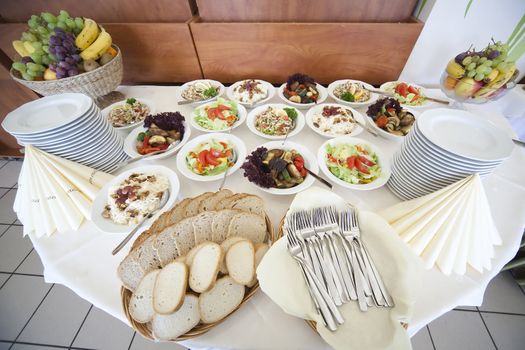 table full of salads, bread and fruits