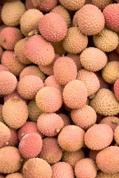 Fresh litchies from Madagascar on a market stall.