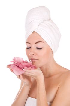 Woman after bath with towel and flower isolated on white