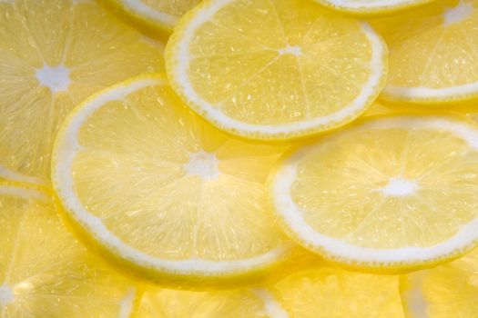 Background with lemon slices illuminated from below close-up (macro) 