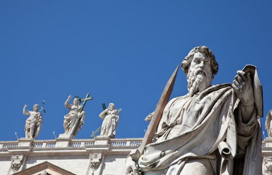 Statues in St. Peter Square (Rome, Italy) with blue sky background