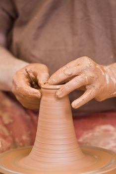 Potter working with clay.