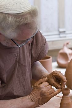 Potter working with clay.