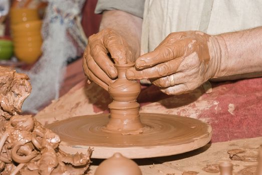 Potter working with clay.