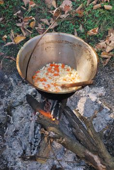 Traditional way of preparing food in a caldron hanging over fire. 