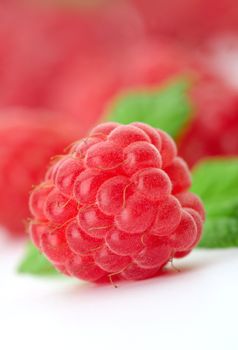 Raspberries with green leaves.This image is focused on one of them