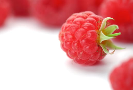 Raspberries with green leaves.This image is focused on one of them