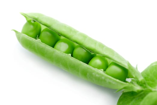 A pea pod revealing peas against white background