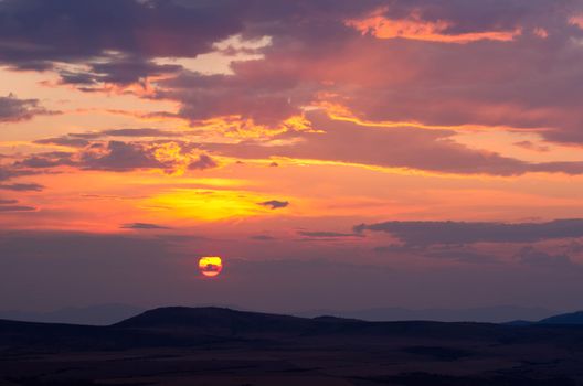 Sunset on a hazy evening (haze caused by forest fires) in late summer, Gallatin County, Montana, USA