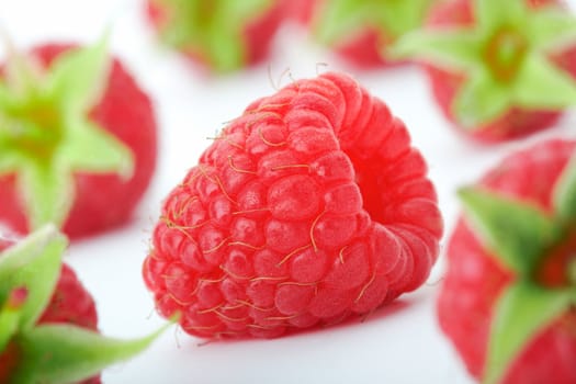 Raspberries with green leaves.This image is focused on one of them