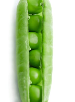 A pea pod revealing peas against white background