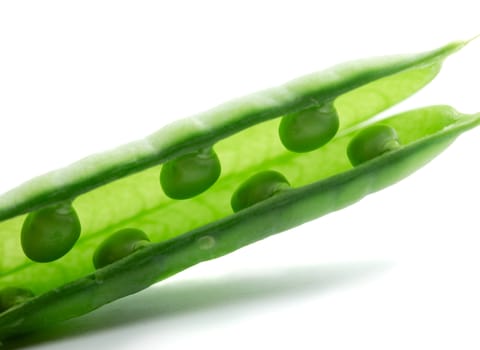 A pea pod revealing peas against white background