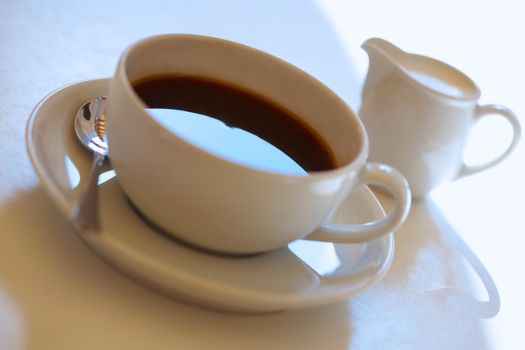 Espresso coffee cup with steel spoon and with cup of milk