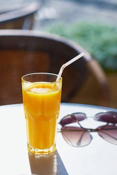 Glass of freshly squeezed orange juice on a table