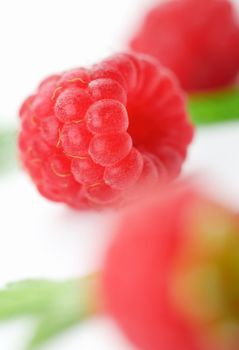 Raspberries with green leaves.This image is focused on one of them