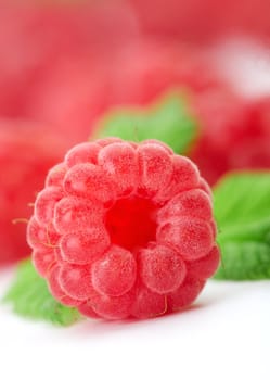 Raspberries with green leaves.This image is focused on one of them