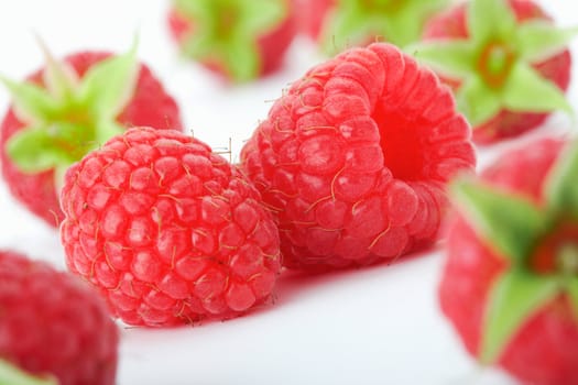 Raspberries with green leaves.This image is focused on one of them